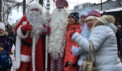 Finland&#39;s Santa, left, and Russia&#39;s Grandfather Frost, 2nd left, meet families in the border town of Lappeenranta, Finland on Monday Dec. 19, 2016, as an annual show of goodwill and neighborly friendship. But despite the jovial ho-ho-hos in the annual show of seasonal goodwill and neighborly friendship, there lies an increasing disquiet in the Nordic nation. (AP Photo/Vitnija Saldava)