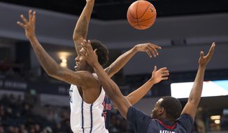 Old Dominion&#39;s Zoran Talley drives to the basket but has the ball knocked away by a Howard player during the first half of an NCAA college basketball game Thursday, Dec. 22, 2016, in Norfolk, Va. (Bill Tiernan/The Virginian-Pilot via AP)