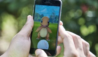 In this Friday, July 22, 2016 file photo, a Pokemon Go player attempts to catch a Charmander character in New Delhi, India. (AP Photo/Thomas Cytrynowicz) **FILE**