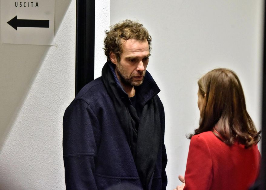 Paula Olsen, mother of slain American woman Ashley Olsen, speaks with her daughter's then boyfriend Federico Fiorentini, left, in a courtroom in Florence, Italy, Thursday, Dec. 22, 2016. A Florence court is debating the fate of Senegalese man Cheik Tidiane Diaw, who is accused of murdering Ashley Olsen in her flat after they met at a nightclub in January 2016. (Maurizio degl'Innocenti/ANSA via AP)