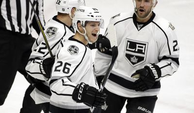 Los Angeles Kings center Nic Dowd (26) celebrates with Trevor Lewis (22) and Alec Martinez (27) after Dowd scored a goal against the Nashville Predators during the third period of an NHL hockey game Thursday, Dec. 22, 2016, in Nashville, Tenn. (AP Photo/Mark Humphrey)