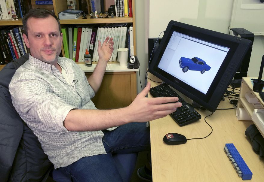 In this Monday, Dec. 19, 2016 photo, Lego master model builder Pete Donner sits at his computer at the company office in Enfield, Conn. The builders use computer software to create models that can take 70 to 150 hours to design and 350 hours to build for full-size characters. (AP Photo/Michael Melia)