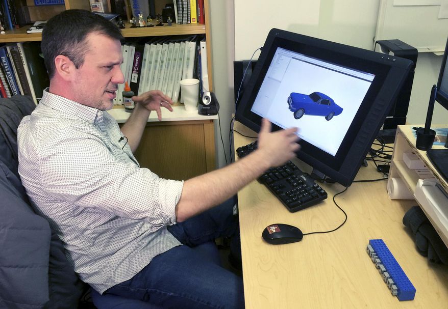 In this Monday, Dec. 19, 2016 photo, Lego master model builder Pete Donner sits at his computer at the company office in Enfield, Conn. The builders use computer software to create models that can take 70 to 150 hours to design and 350 hours to build for full-size characters. (AP Photo/Michael Melia)