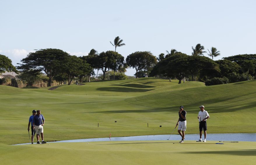 From left, Greg Orme, Bobby Titcomb, Darrell Harrington and President Barack Obama golf the 18th green at Kapolei Golf Club, in Kapolei, Hawaii, Wednesday, Dec. 21, 2016. (AP Photo/Carolyn Kaster)