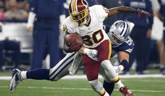 FILE - In this Thursday, Nov. 24, 2016 file photo, Washington Redskins wide receiver Jamison Crowder (80) attempts to escape a tackle by Dallas Cowboys&#x27; Sean Lee (50) during the second half of an NFL football game in Arlington, Texas. This has not been the most watchable of NFL seasons, although the action and entertainment value has picked up in the second half of the schedule. What has emerged is the rise of four teams who are downright fun to watch: the Falcons, Titans, Redskins and Raiders. (AP Photo/Michael Ainsworth, File)