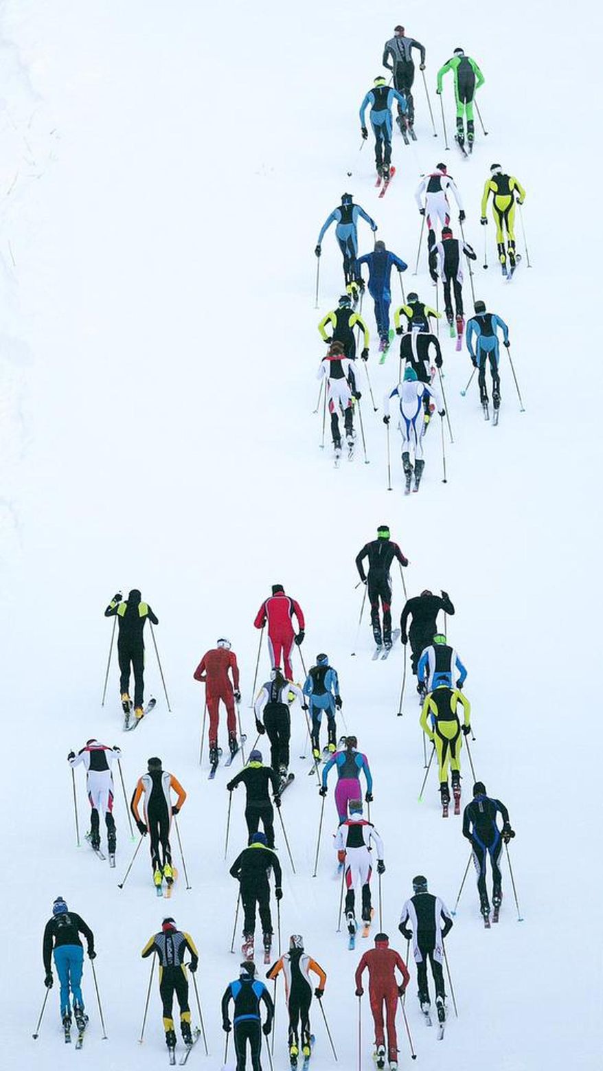 ADVANCE FOR WEEKEND EDITIONS, DEC. 24-25 - In this Dec. 16, 2016 photo, ski mountaineering racers make their way up the 45th Parallel run during the Northwest Passage Ski Mountaineering Vertical Race at Brundage Ski resort in McCall, Idaho. The vertical race featured a sprint to the top of the mountain that included 530 meters of elevation gain. (Kyle Green/Idaho Statesman via AP)