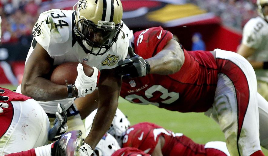 FILE - In this Dec. 18, 2016, file photo, New Orleans Saints running back Tim Hightower (34) scores a touchdown as Arizona Cardinals defensive end Calais Campbell (93) defends during the second half of an NFL football game in Glendale, Ariz. Hightower has rushed for 490 yards and three touchdowns this season, making this the third-most productive season of his career so far. (AP Photo/Ross D. Franklin, File)