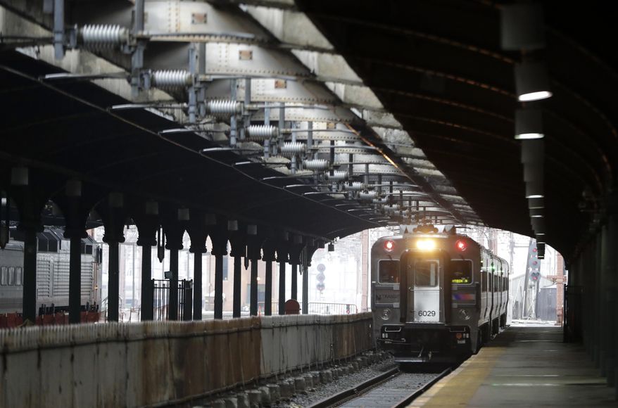 In a photograph taken Wednesday, Nov. 30, 2016, a New Jersey Transit train approaches the Hoboken Train Terminal on Track 4 in Hoboken, N.J. Only one of the terminal's 17 tracks features a modern bumping post designed to stop a runaway train. The post on Track 15 is the only post featuring a modern post. The other posts were installed more than 100 years ago and recently became relevant in the wake of the New Jersey Transit train crash that occurred Sept. 29, 2016. (AP Photo/Julio Cortez)