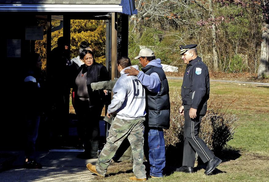 In this Tuesday, Dec. 20, 2016 photo a man is led into the Narragansett tribe's administration building following a minor scuffle near the entrance to the building, in Charlestown, R.I. Members of a recently elected Narragansett Tribal Council said they took over the administration building Tuesday, Dec. 20 because Chief Sachem Matthew Thomas has refused to relinquish power after they impeached him in October. (Harold Hanka/The Sun via AP)