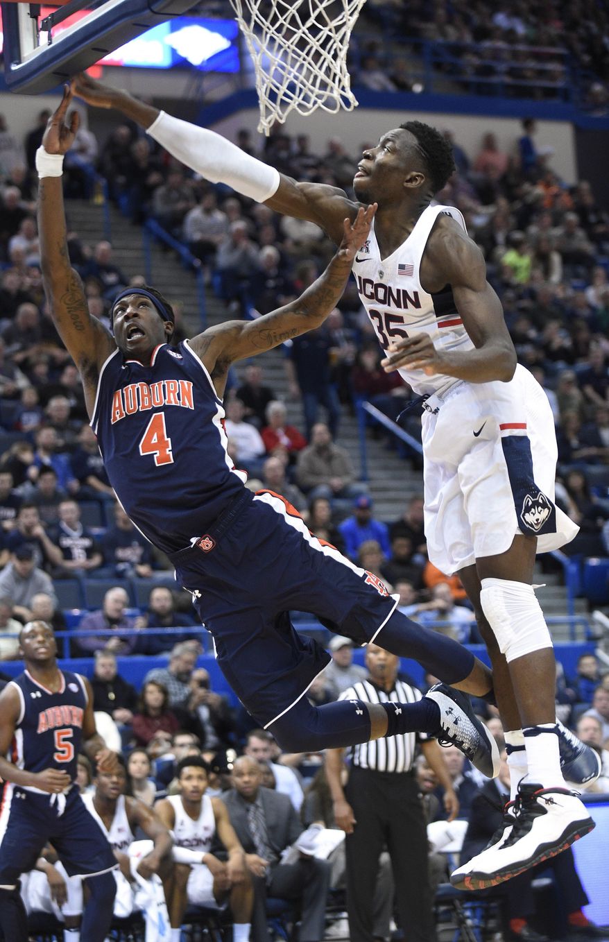 Connecticut's Amida Brimah (35) blocks the shot of Auburn's T.J. Dunans (4) during the first half of an NCAA college basketball game in Hartford, Conn., on Friday, Dec. 23, 2016. (AP Photo/Fred Beckham)
