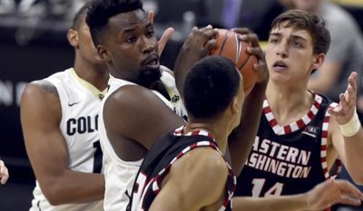 Colorado's Wesley Gordon battles with Eastern Washington's Jacob Wiley and Mason Peatling during the second half of an NCAA college basketball game, Thursday, Dec. 22, 2016 in Boulder, Colo. (Cliff Grassmick/Daily Camera via AP)