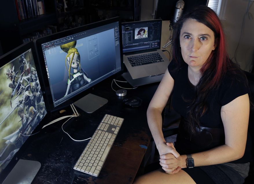 Brianna Wu, a software engineer and video-game developer, sits at her workstation in Boston, in this July 25, 2016, file photo. Wu, the co-founder of a gaming software company who made headlines two years ago when she was threatened, said she wants to run for one of Massachusetts&#39; nine U.S. House seats. Wu said her platform will focus on privacy rights and online harassment. (AP Photo/Elise Amendola, File)
