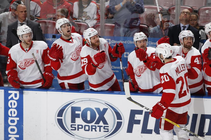 Detroit Red Wings left wing Drew Miller (20) is congratulated by teammates after scoring a goal against the Florida Panthers during the third period of an NHL hockey game, Friday, Dec. 23, 2016, in Sunrise, Fla. (AP Photo/Joel Auerbach)