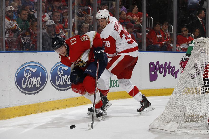 Florida Panthers defenseman Mark Pysyk (13) and Detroit Red Wings left wing Anthony Mantha (39) battle for control of the puck behind the net during the second period of an NHL hockey game, Friday, Dec. 23, 2016, in Sunrise, Fla. (AP Photo/Joel Auerbach)