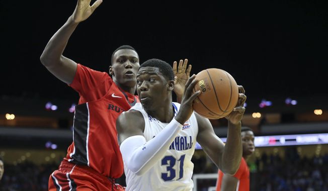 Seton Hall forward Angel Delgado (31) looks to take a shot as Rutgers forward Shaquille Doorson defends during the first half of an NCAA college basketball game Friday, Dec. 23, 2016, in Newark, N.J. (AP Photo/Mel Evans)