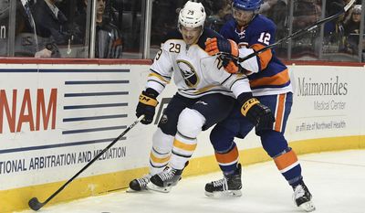 New York Islanders left wing Josh Bailey, right, and Buffalo Sabres defenseman Jake McCabe work along the boards during the first period of an NHL hockey game in New York, Friday, Dec. 23, 2016. (Kathleen Malone-Van Dyke/Newsday via AP)