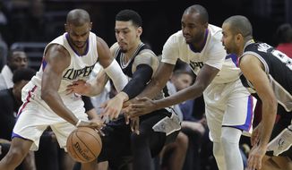 Los Angeles Clippers&#x27; Chris Paul, left, and Luc Richard Mbah a Moute, second from right, vie for the ball with San Antonio Spurs&#x27; Danny Green and Tony Parker, right, during the first half of an NBA basketball game Thursday, Dec. 22, 2016, in Los Angeles. (AP Photo/Jae C. Hong)