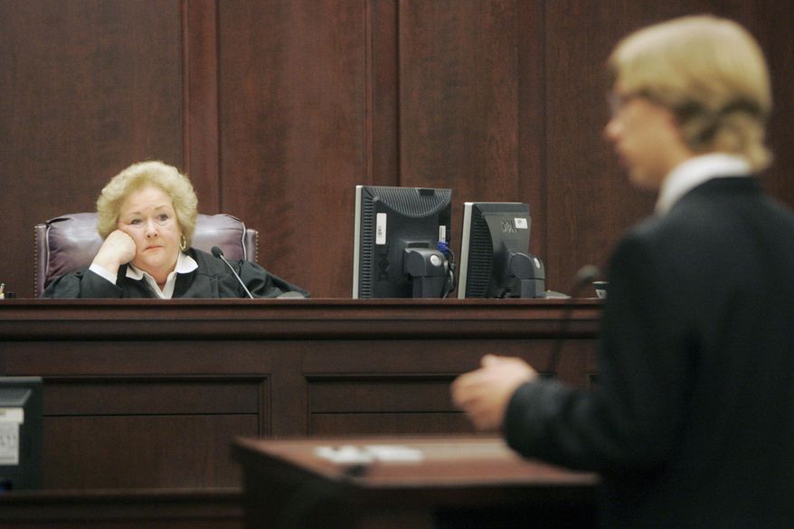 In this Saturday, Feb. 6, 2010 photo, U.S. District Judge Janis Graham Jack listens as Zachary Cohen, a sophomore at Calallen High School, makes the closing arguments for his team during the Regional High School Mock Trial competition in Texas. The federal judge who ruled that Texas' foster care system is unconstitutionally broken has been named The Dallas Morning News' Texan of the Year. The newspaper announced Friday, Dec. 23, 2016, that Jack was being recognized because she "punctured our comfortable obliviousness to the appalling treatment" being endured by the 12,000 children labeled permanent wards of the state. (Michael Zamora /Corpus Christi Caller-Times via AP)