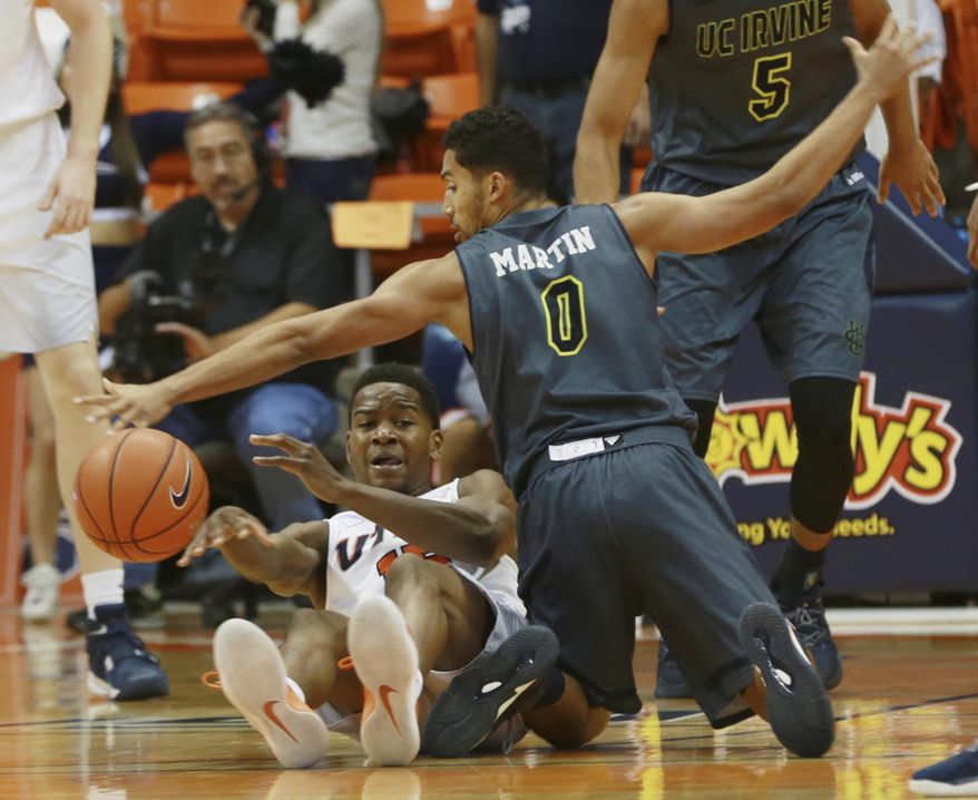 UTEP's Dominic Artis makes a seated pass while being guarded by UC Irvine's Jaron Martin during the second half of an NCAA college basketball game Thursday, Dec. 22, 2016, in El Paso, Texas. (Victor Calzada/The El Paso Times via AP)