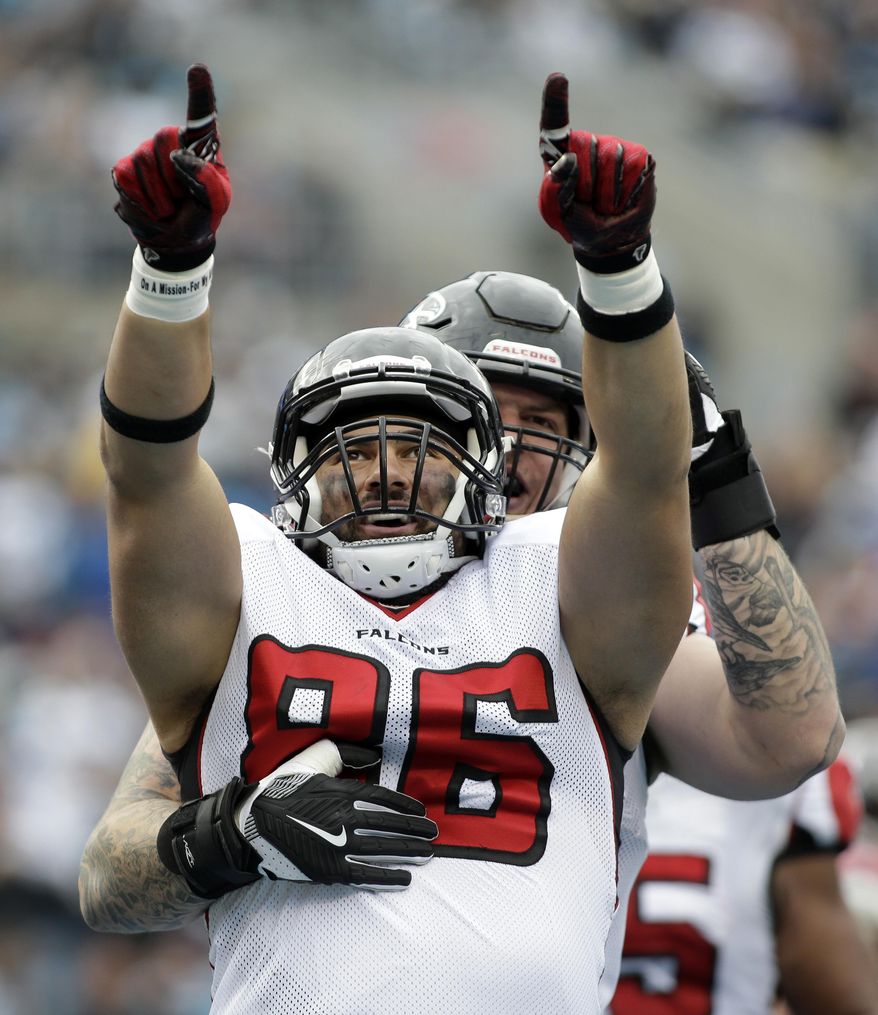 Atlanta Falcons' D.J. Tialavea (86) celebrates his touchdown catch against the Carolina Panthers in the first half of an NFL football game in Charlotte, N.C., Saturday, Dec. 24, 2016. (AP Photo/Bob Leverone)