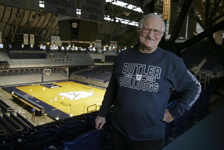 In this Tuesday, Dec. 20, 2016 photo, Bobby Plump, star of the 1954 Milan state championship basketball team featured in the movie "Hoosiers," poses in Hinkle Fieldhouse in Indianapolis. Hinkle Fieldhouse was the site of championship game and the filming of the final game in the movie. (AP Photo/Michael Conroy)