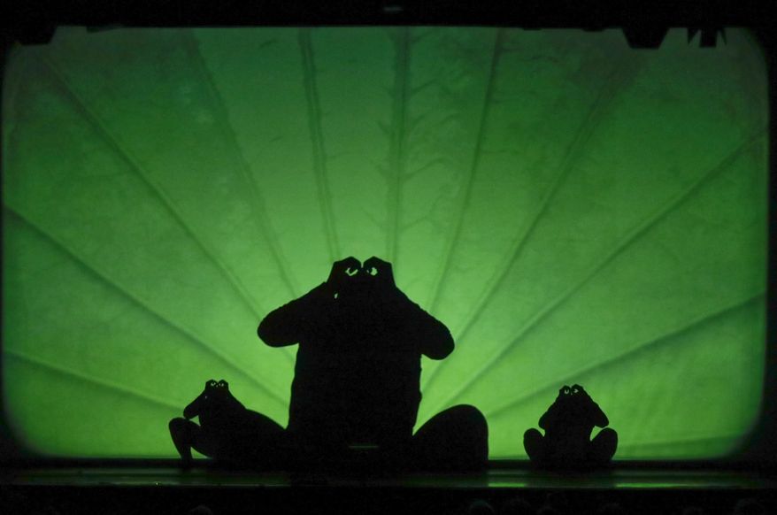 In this photo taken on Tuesday, Dec. 20, 2016, dancers of the U.S. company 'Catapult' create frogs, during their show 'Magic Shadows', in Milan, Italy. Dancers in the company create shadow sculptures with their bodies, giving a contemporary twist to the ancient Chinese art of shadow theaters. (AP Photo/Luca Bruno)