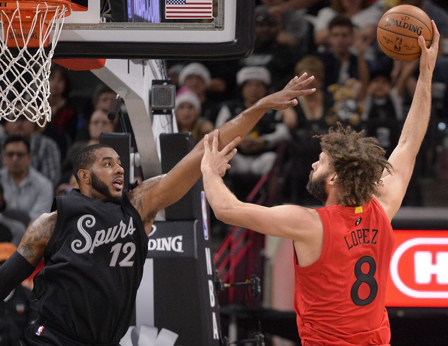Chicago Bulls center Robin Lopez (8) shoots against San Antonio Spurs forward LaMarcus Aldridge during the first half of an NBA basketball game Sunday, Dec. 25, 2016, in San Antonio. (AP Photo/Darren Abate)