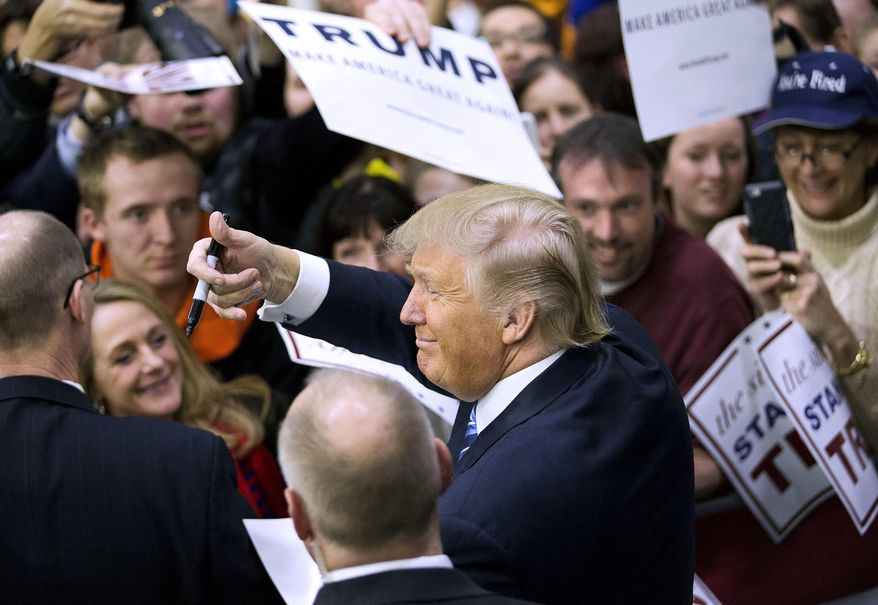 FILE - In this Feb. 7, 2016 file photo, Republican presidential candidate Donald Trump gestures to the crowd as he signs autographs during a campaign event at Plymouth State University in Plymouth, N.H. Trump broke with campaign tradition and held rallies over house parties to win the New Hampshire primary, one of the state's top stories in 2016. (AP Photo/David Goldman, File)