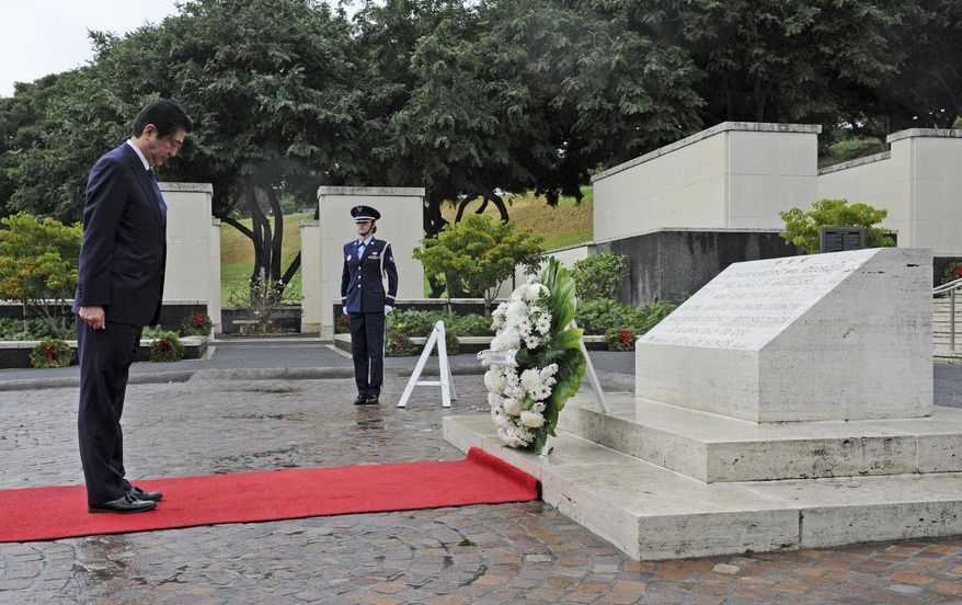 Japanese Prime Minister Shinzo Abe visits the National Memorial Cemetery of the Pacific to place a wreath at the Honolulu Memorial, Monday, Dec. 26, 2016, in Honolulu. He stood for a moment of silence after the wreath laying. (Bruce Asato /The Star-Advertiser via AP)
