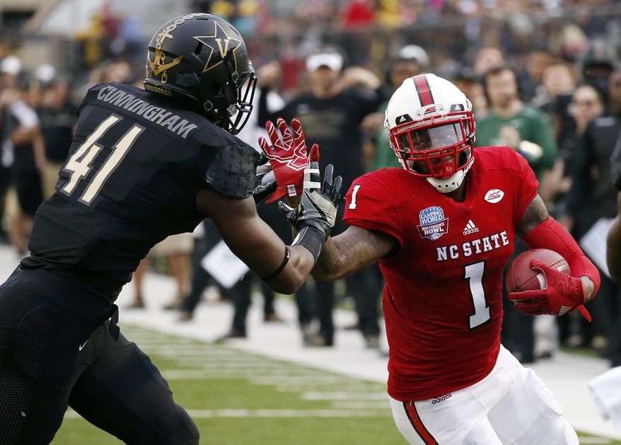 North Carolina State tight end Jaylen Samuels (1) holds off Vanderbilt linebacker Zach Cunningham (41) for a first down pass reception in the first half of the Camping World Independence Bowl NCAA college football game in Shreveport, La., Monday, Dec. 26, 2016. North Carolina State won 41-17. (AP Photo/Rogelio V. Solis)
