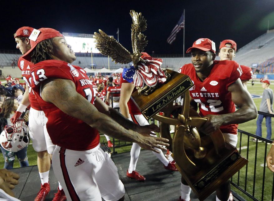 North Carolina State players hoist the winners trophy of the Camping World Independence Bowl NCAA college football game after defeating Vanderbilt 41-17 in Shreveport, La., Monday, Dec. 26, 2016. (AP Photo/Rogelio V. Solis)