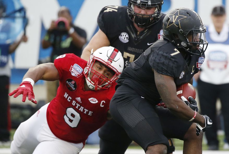North Carolina State defensive end Bradley Chubb (9) tackles Vanderbilt running back Ralph Webb (7) the first half of the Camping World Independence Bowl NCAA college football game in Shreveport, La., Monday, Dec. 26, 2016. (AP Photo/Rogelio V. Solis)