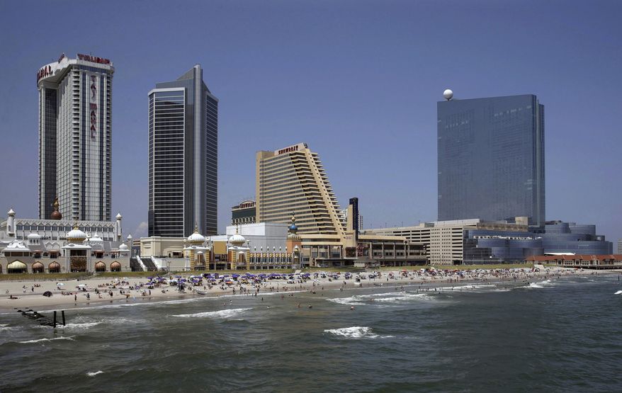 FILE - In this July 23, 2014, file photograph, the closed casinos, Revel Casino Hotel, right, stands along the Boardwalk near Trump Taj Mahal Casino, left, with its Chairman Tower, and the Showboat Casino Hotel, second right, in Atlantic City, N.J. The troubled gambling resort saw the Trump Taj Mahal casino close, putting a final end to Trump’s legacy in Atlantic City. (AP Photo/Mel Evans, File)