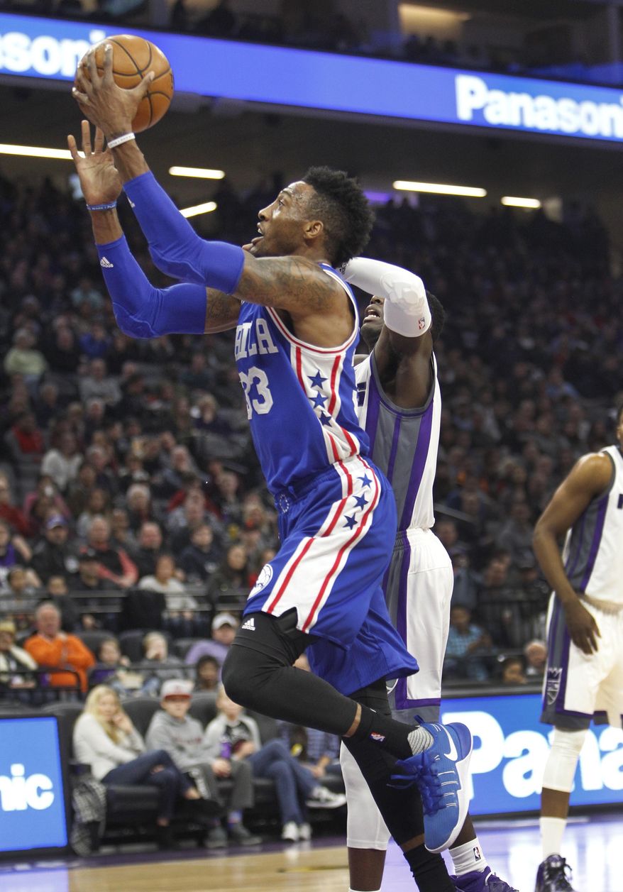 Philadelphia 76ers forward Robert Covington (33) drives to the basket past Sacramento Kings defender Darren Collison (7) during the first half of an NBA basketball game in Sacramento, Calif., Monday, Dec. 26, 2016. (AP Photo/Steve Yeater)