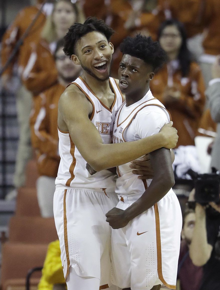 Texas center James Banks (4) celebrates a sore by guard Andrew Jones, right, during the first half of the team's NCAA college basketball game against Kent State, Tuesday, Dec. 27, 2016, in Austin, Texas. (AP Photo/Eric Gay)