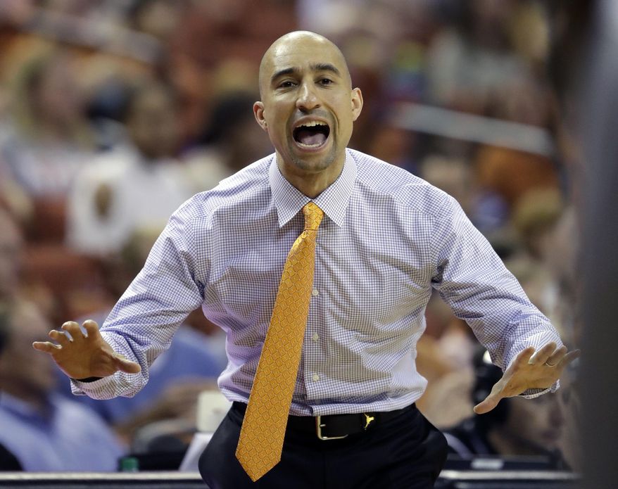 Texas coach Shaka Smart calls to his players during the first half on an NCAA college basketball game against Kent State, Tuesday, Dec. 27, 2016, in Austin, Texas. (AP Photo/Eric Gay)