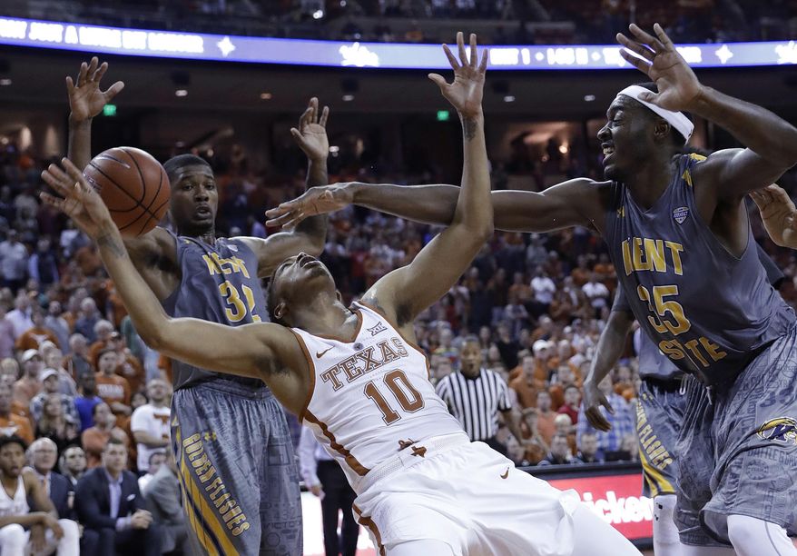 Texas guard Eric Davis Jr. (10) is blocked by Kent State forward Jimmy Hall (35) as he tries to score during the final seconds of an NCAA college basketball game, Tuesday, Dec. 27, 2016, in Austin, Texas. Kent State won 63-58. (AP Photo/Eric Gay)