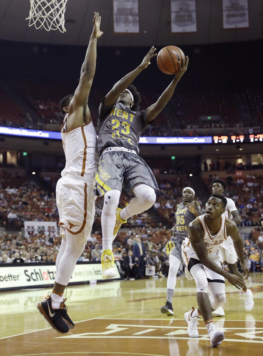 Kent State guard Jaylin Walker (23) shoots over Texas forward Shaquille Cleare, left, during the first half of an NCAA college basketball game, Tuesday, Dec. 27, 2016, in Austin, Texas. (AP Photo/Eric Gay)