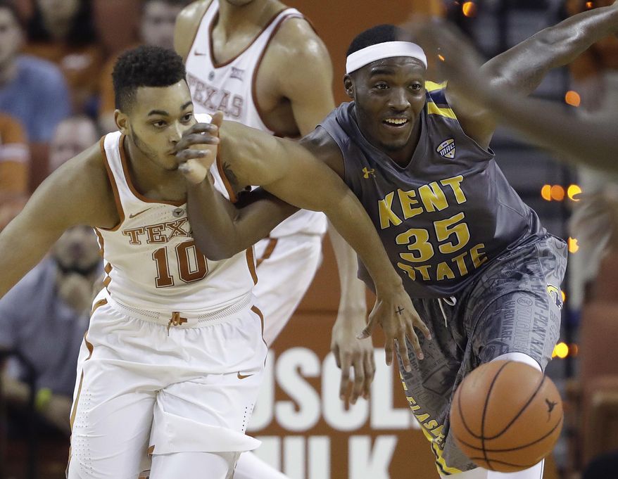 Texas guard Eric Davis Jr. (10) and Kent State forward Jimmy Hall (35) scramble for a loose ball during the second half of an NCAA college basketball game, Tuesday, Dec. 27, 2016, in Austin, Texas. Kent State won 63-58. (AP Photo/Eric Gay)