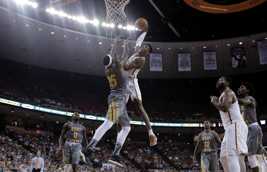 Texas guard Kerwin Roach Jr. (12) drives to the basket against Kent State forward Jimmy Hall (35) during the second half of an NCAA college basketball game, Tuesday, Dec. 27, 2016, in Austin. Kent State won 63-58. (AP Photo/Eric Gay)