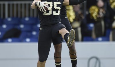 Wake Forest tight end Cam Serigne, left, and wide receiver Scotty Washington celebrate a touchdown against Temple during the first half of the Military Bowl NCAA college football game, Tuesday, Dec. 27, 2016 in Annapolis, Md. (AP Photo/Gail Burton)