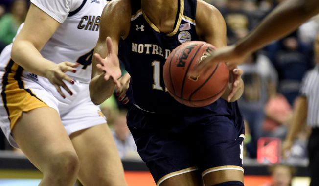 Notre Dame Forward Brianna Turner (11) drives past Arianne Whitaker (4) of Chattanooga in the first half of an NCAA college basketball game, Tuesday, Dec. 27, 2016, in Chattanooga, Tenn. (AP Photo/Billy Weeks)