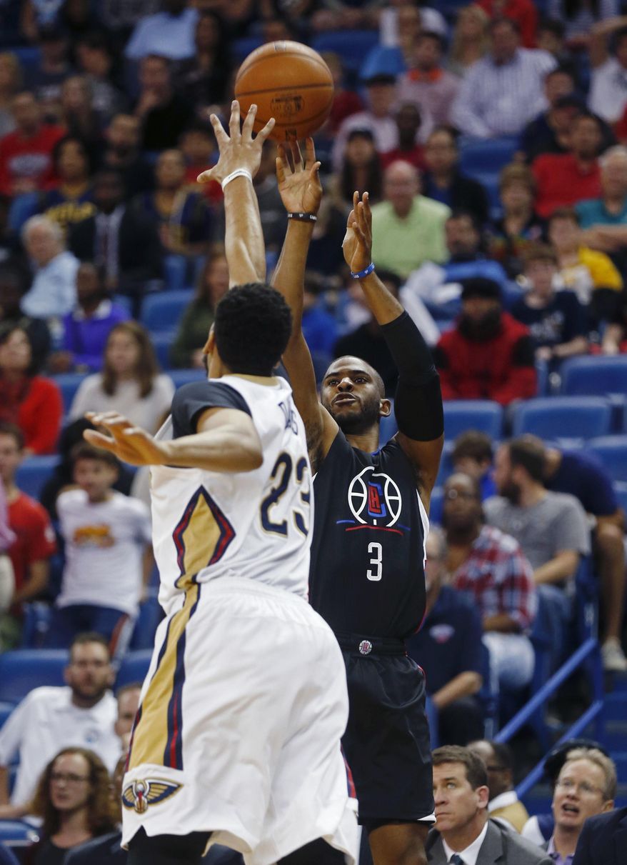 Los Angeles Clippers guard Chris Paul (3) shoots a 3-point basket against New Orleans Pelicans forward Anthony Davis (23) during the first half of an NBA basketball game in New Orleans, Wednesday, Dec. 28, 2016. (AP Photo/Gerald Herbert)