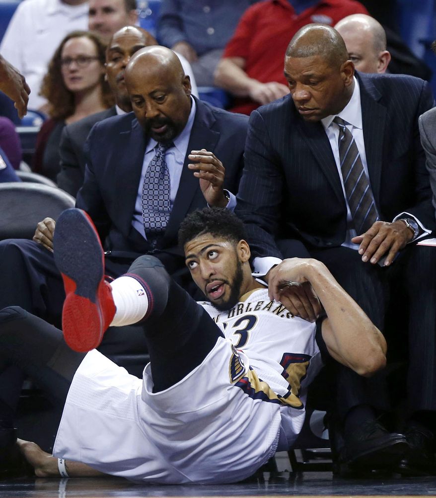 Los Angeles Clippers coach Doc Rivers puts his hand on the shoulder of New Orleans Pelicans forward Anthony Davis after Davis fell into the bench area during the first half of an NBA basketball game in New Orleans, Wednesday, Dec. 28, 2016. (AP Photo/Gerald Herbert)