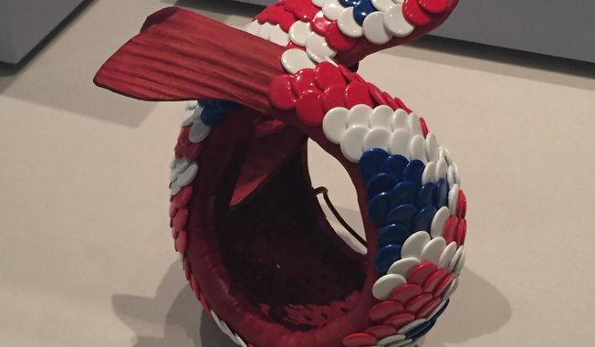 This photo taken on Dec. 2, 2016 at the Los Angeles County Museum of Art in Los Angeles shows Swiss jeweler David Bielander&#x27;s 2013 &amp;quot;Koi&amp;quot; bracelet, made with multi-colored thumb tacks and resembling a fish, in the &amp;quot;Beyond Bling: Jewelry from the Lois Boardman Collection&amp;quot; exhibit. The exhibit features 50 jewelry pieces made from unconventional materials and belonging to Southern California collector Boardman&#x27;s 300-piece jewelry collection, recently donated to the museum. The exhibit opened on Oct. 2, and runs until Feb. 5, 2017. (Solvej Schou via AP)