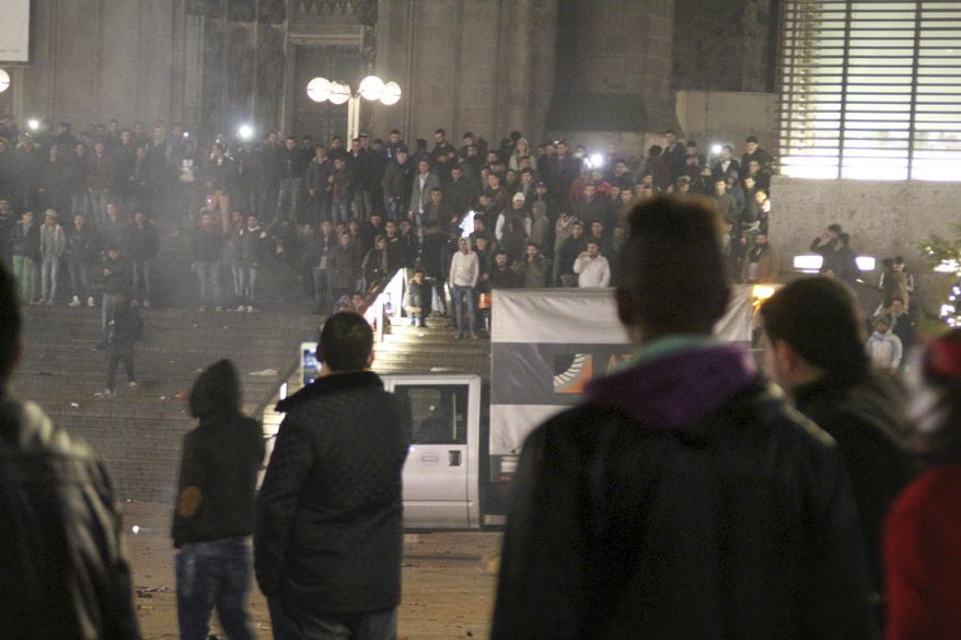 FILE -In this Dec. 31, 2015 file picture, persons gather at the Cologne, Germany, main station. Police in Cologne have banned a far-right demonstration on New Year’s Eve 2016 as they work to prevent a repeat of last year’s disorder and say they’ll put obstacles in place to prevent anyone driving into crowds. Police chief Juergen Mathies said Wednesday Dec. 28, 2016 he refused permission for a protest by the far-right National Democratic Party. (Markus Boehm/dpa via AP,file)