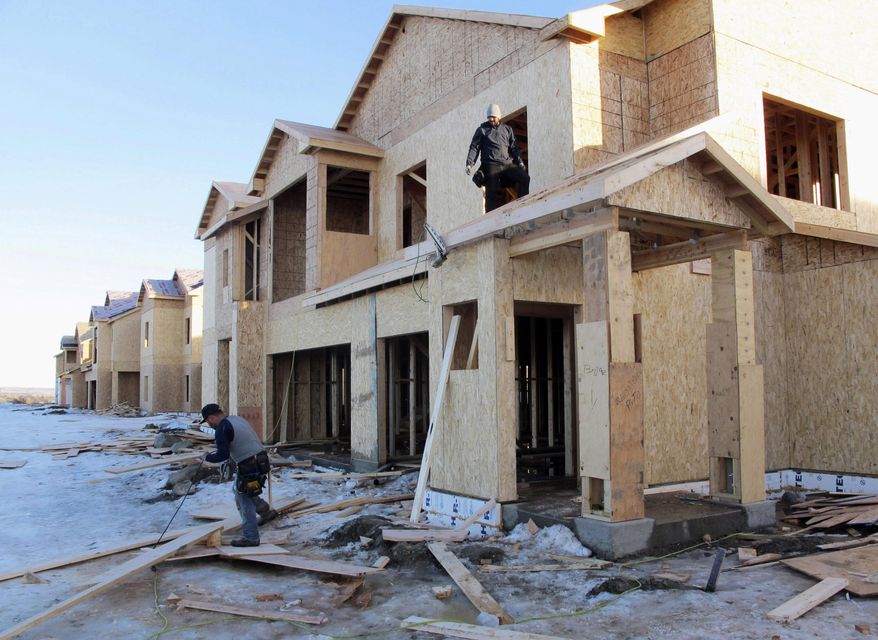 FILE - In this Jan. 29, 2016, file photo, carpenters work on an apartment complex in Williston, N.D. A state income tax credit that helped build hundreds of affordable housing units in North Dakota's oil patch will expire at year's end, with lawmakers and the new governor signaling that they have no appetite to renew it amid a lackluster economy due to prolonged slump in crude and crop prices. (AP Photo/James MacPherson, File)