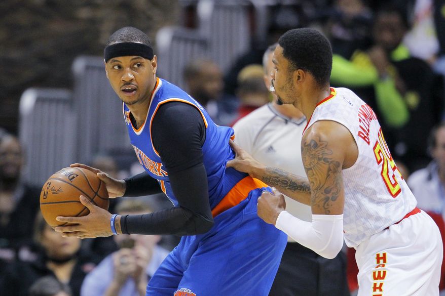 New York Knicks forward Carmelo Anthony (7) is defended by Atlanta Hawks forward Kent Bazemore (24) in the first half of an NBA basketball game between the New York Knicks and Atlanta Hawks on Wednesday, Dec. 28, 2016, in Atlanta. (AP Photo/Todd Kirkland)