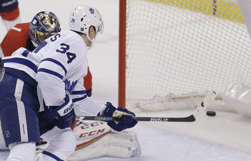 Toronto Maple Leafs center Auston Matthews (34) scores against the Florida Panthers during the first period of an NHL hockey game, Wednesday, Dec. 28, 2016, in Sunrise, Fla. (AP Photo/Alan Diaz)