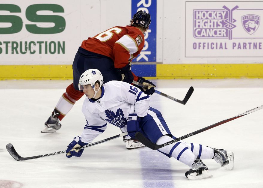 Toronto Maple Leafs center Mitchell Marner (16) falls after colliding with Florida Panthers&#x27; Jakub Kindl (46) during the second period of an NHL hockey game, Wednesday, Dec. 28, 2016, in Sunrise, Fla. (AP Photo/Alan Diaz)